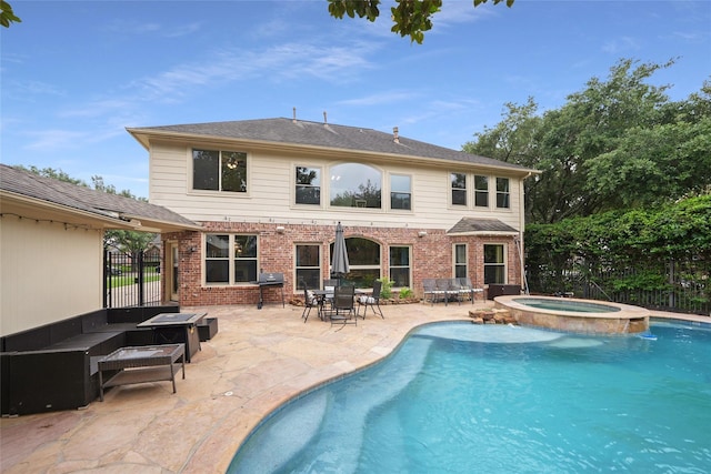 view of pool with a grill, an in ground hot tub, and a patio