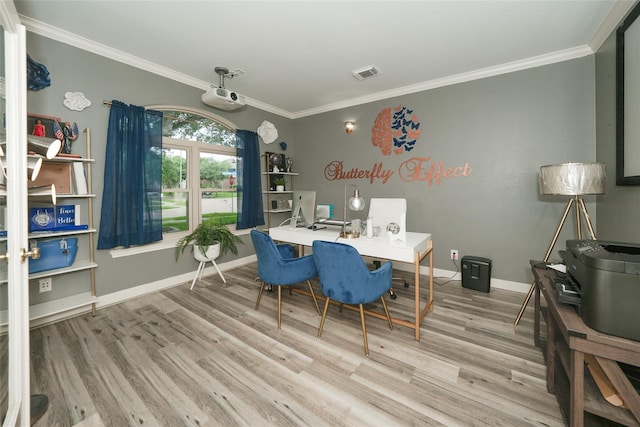 dining area featuring ornamental molding and light hardwood / wood-style flooring