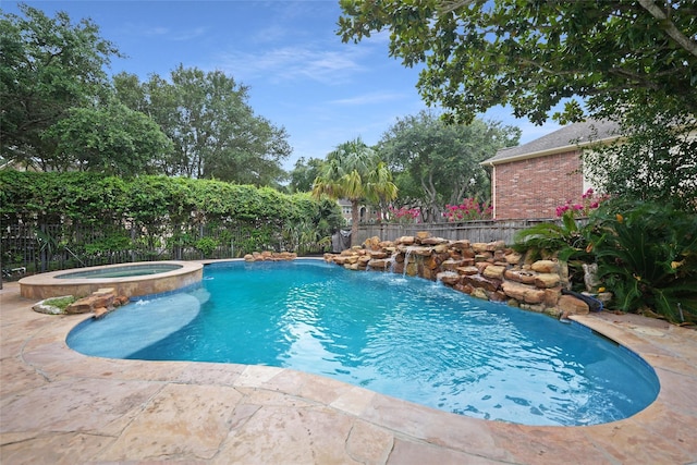 view of pool with pool water feature and an in ground hot tub