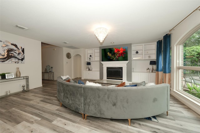 living room featuring light wood-type flooring and a wealth of natural light