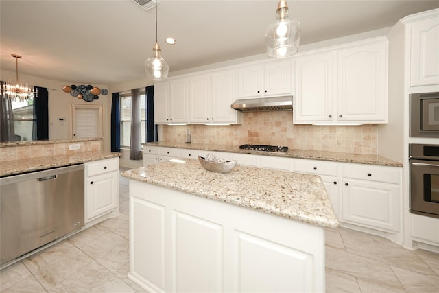 kitchen with stainless steel appliances, white cabinetry, a kitchen island, and hanging light fixtures