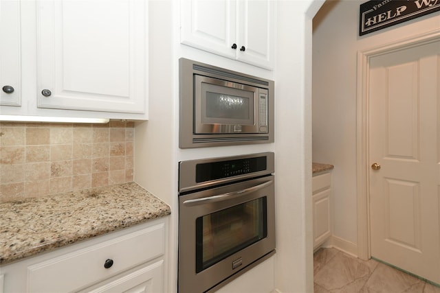 kitchen featuring backsplash, light stone counters, white cabinets, and stainless steel appliances