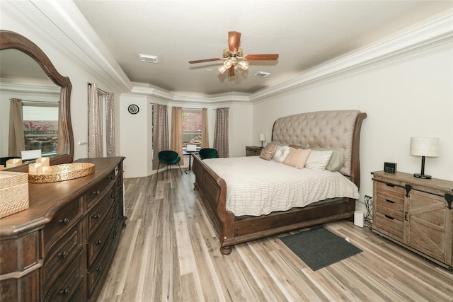 bedroom with ceiling fan, light hardwood / wood-style flooring, and crown molding