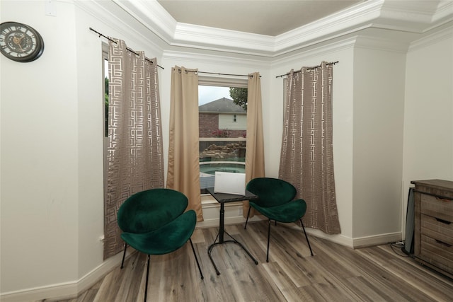 sitting room with hardwood / wood-style floors and ornamental molding