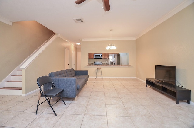 tiled living room featuring ceiling fan with notable chandelier and ornamental molding