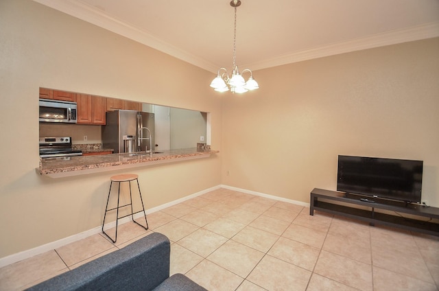 kitchen featuring kitchen peninsula, appliances with stainless steel finishes, crown molding, and a notable chandelier