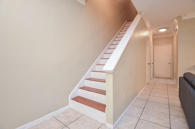 stairs with tile patterned flooring and crown molding