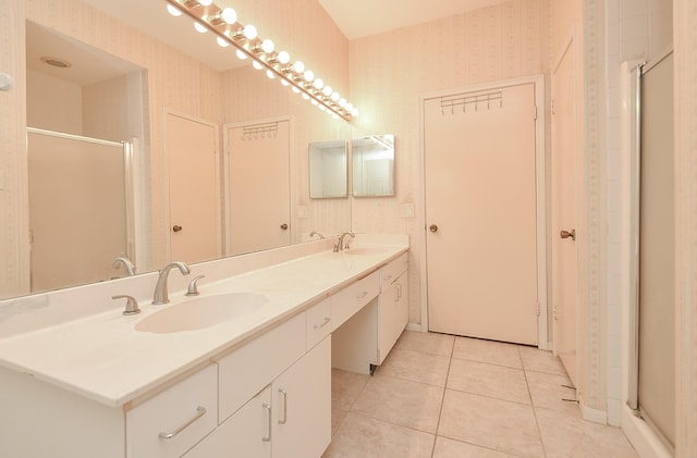 bathroom with tile patterned floors, vanity, and an enclosed shower