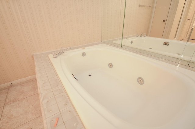 bathroom featuring tile patterned flooring and tiled tub