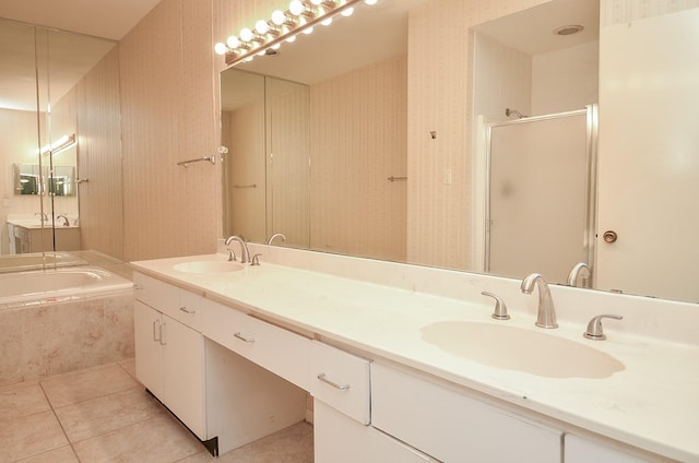 bathroom featuring shower with separate bathtub, vanity, and tile patterned floors