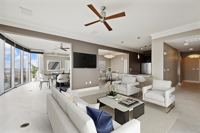 living room with ceiling fan and ornamental molding