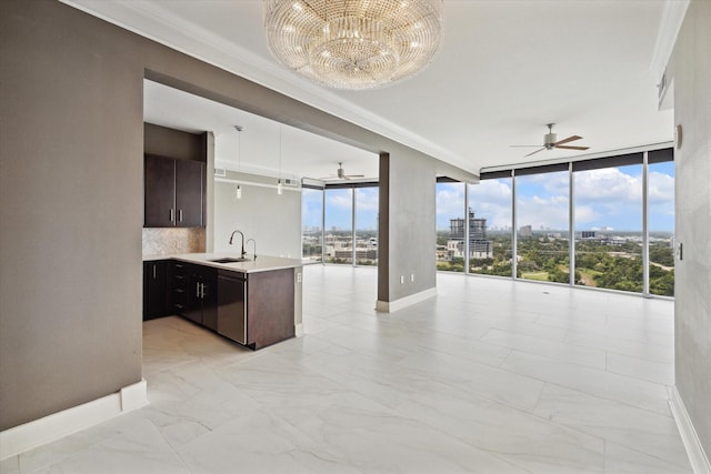 kitchen featuring floor to ceiling windows, backsplash, crown molding, sink, and dark brown cabinetry