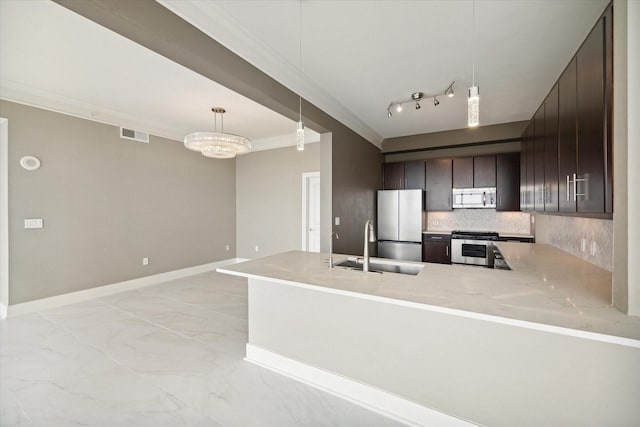 kitchen with kitchen peninsula, dark brown cabinetry, stainless steel appliances, an inviting chandelier, and hanging light fixtures