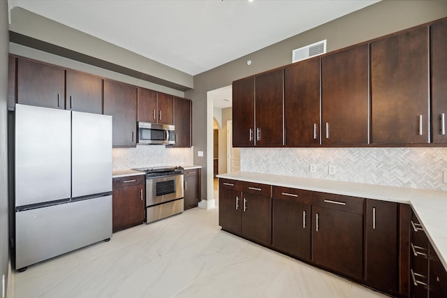 kitchen with backsplash, dark brown cabinets, and stainless steel appliances