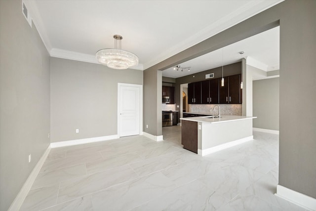 kitchen with dark brown cabinetry, hanging light fixtures, tasteful backsplash, a chandelier, and stainless steel stove