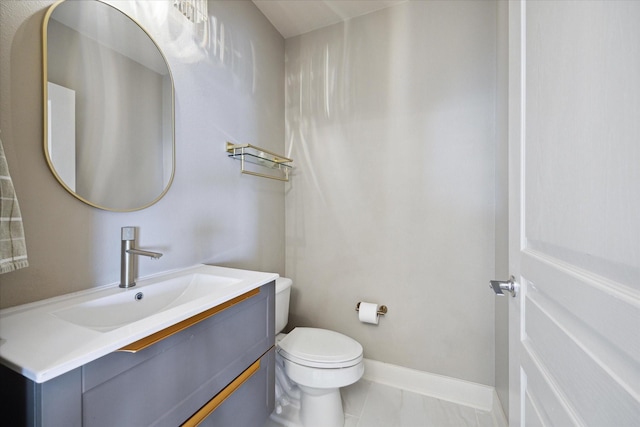 bathroom featuring tile patterned floors, vanity, and toilet