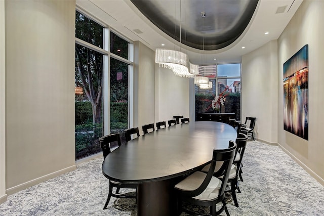 dining room featuring a tray ceiling and an inviting chandelier