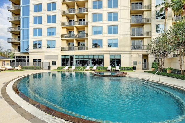 view of swimming pool featuring a community hot tub