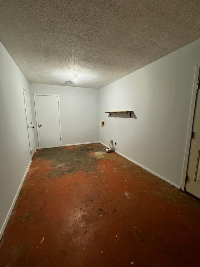 spare room with a textured ceiling