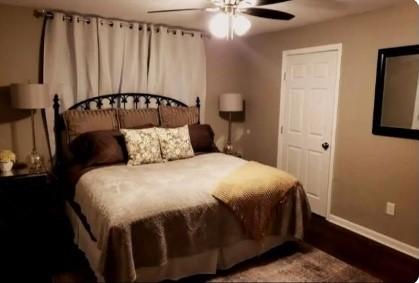 bedroom with ceiling fan and wood-type flooring