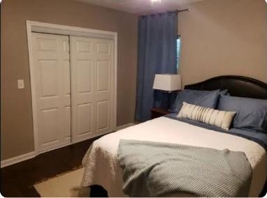 bedroom featuring a closet and dark hardwood / wood-style floors