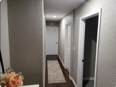 hallway with dark wood-type flooring