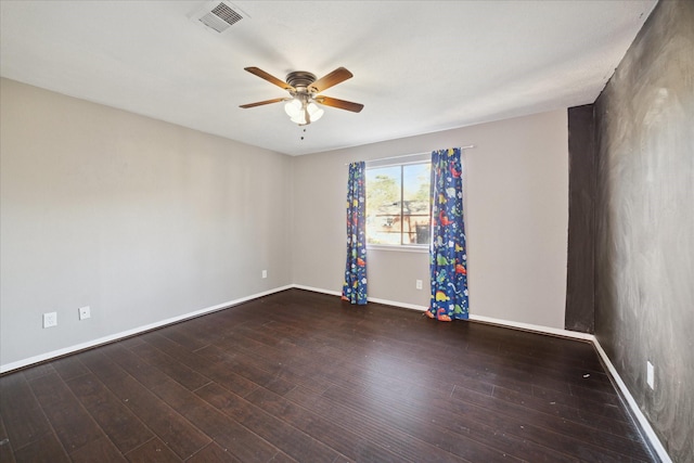 empty room with ceiling fan and dark wood-type flooring