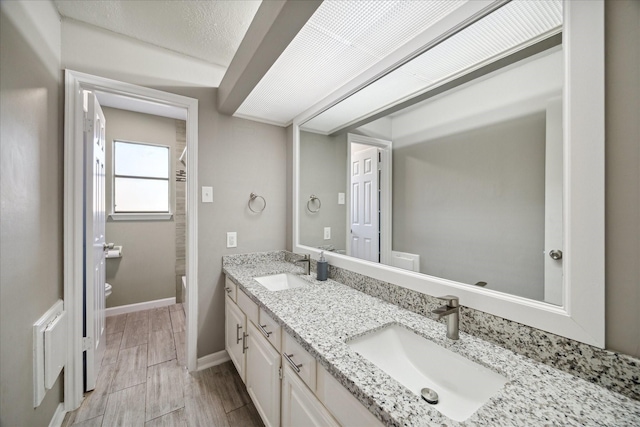 bathroom with hardwood / wood-style floors, vanity, and toilet