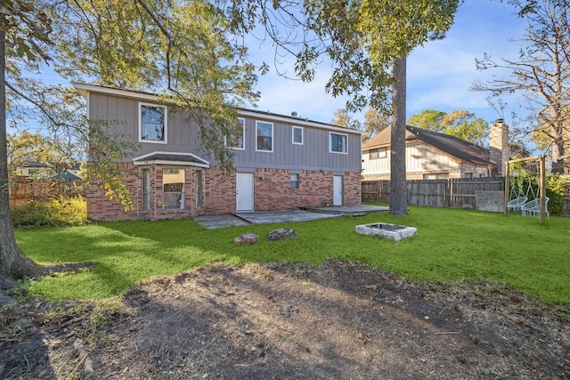 back of property featuring a patio area and a yard