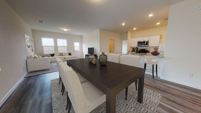 dining area featuring dark wood-style floors, recessed lighting, visible vents, and baseboards