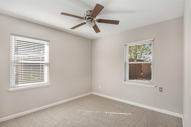 spare room featuring ceiling fan and carpet floors