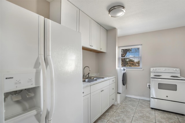 washroom with washer / dryer, light tile patterned floors, and sink