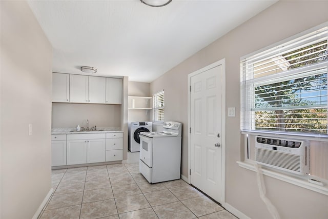 laundry area featuring light tile patterned flooring, washing machine and dryer, cooling unit, and sink