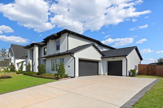 view of front of property with a front yard and a garage