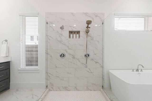 bathroom featuring shower with separate bathtub and vanity