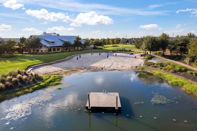 view of dock featuring a yard and a water view