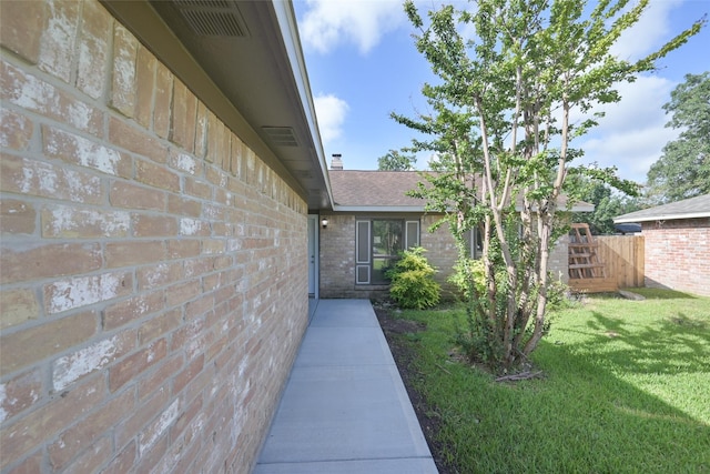 entrance to property with a yard