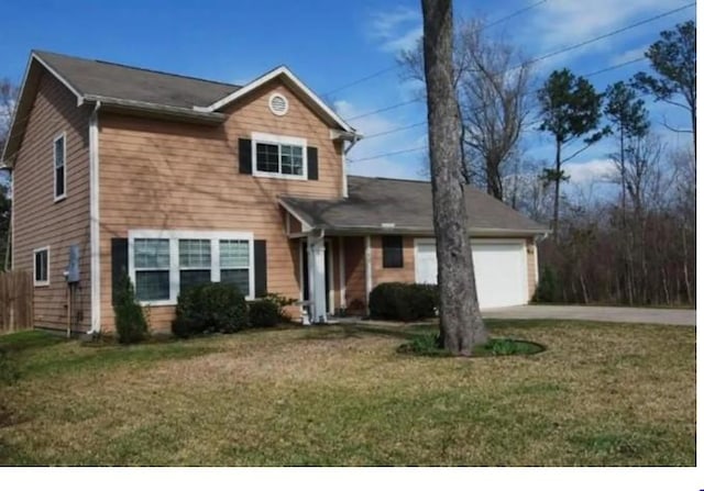 front of property featuring a front yard and a garage