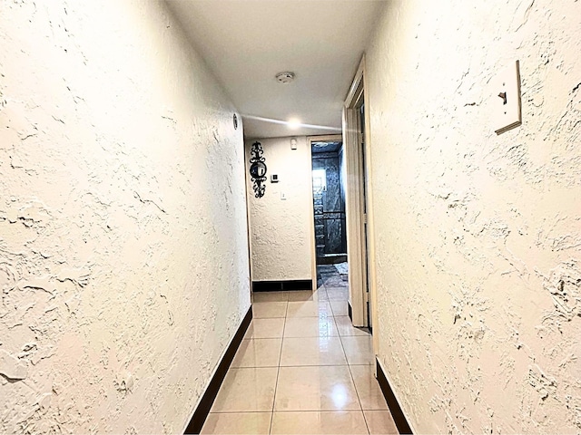 hallway featuring light tile patterned floors