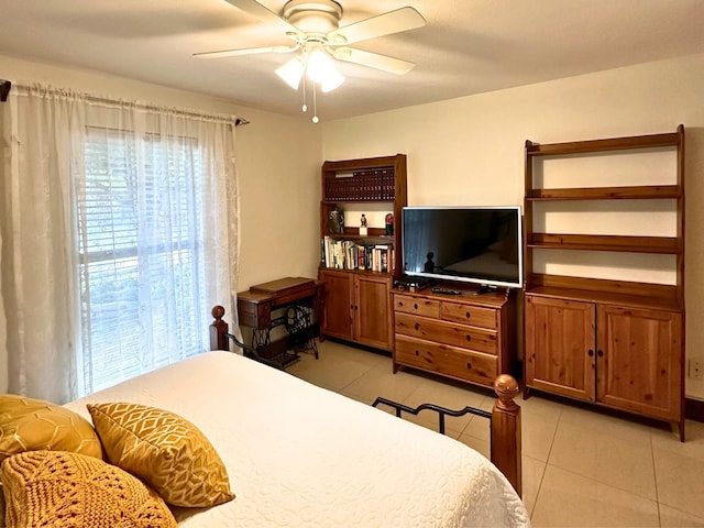 tiled bedroom featuring ceiling fan