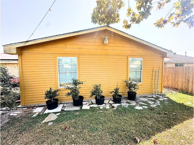 view of property exterior with a yard