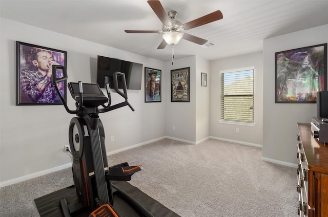 exercise area featuring ceiling fan and light colored carpet