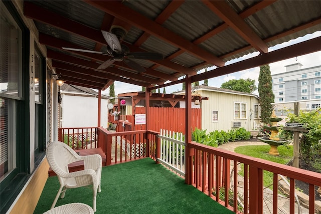 wooden terrace featuring ceiling fan and covered porch