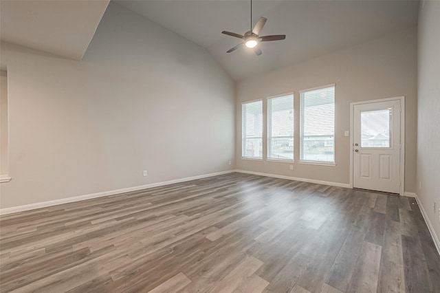 spare room with light hardwood / wood-style floors, ceiling fan, and lofted ceiling