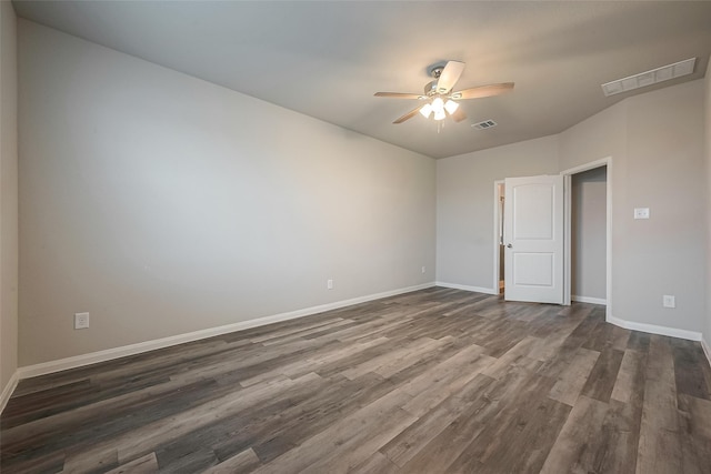 empty room featuring ceiling fan and dark hardwood / wood-style flooring