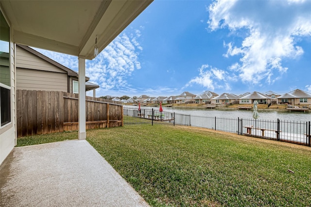 view of yard with a water view and a patio area