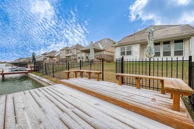 deck featuring a water view and a lawn