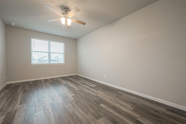 empty room with ceiling fan and dark wood-type flooring