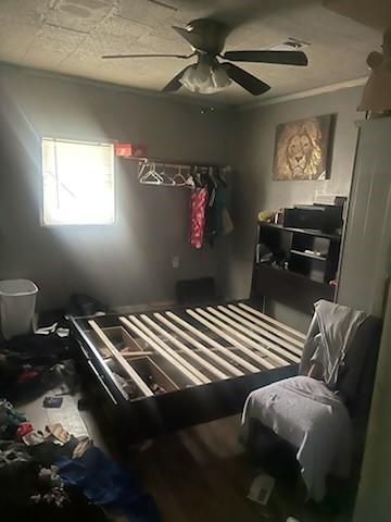 bedroom featuring ceiling fan and ornamental molding