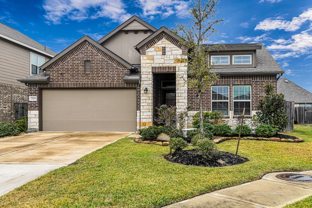 view of front of house with a garage and a front lawn